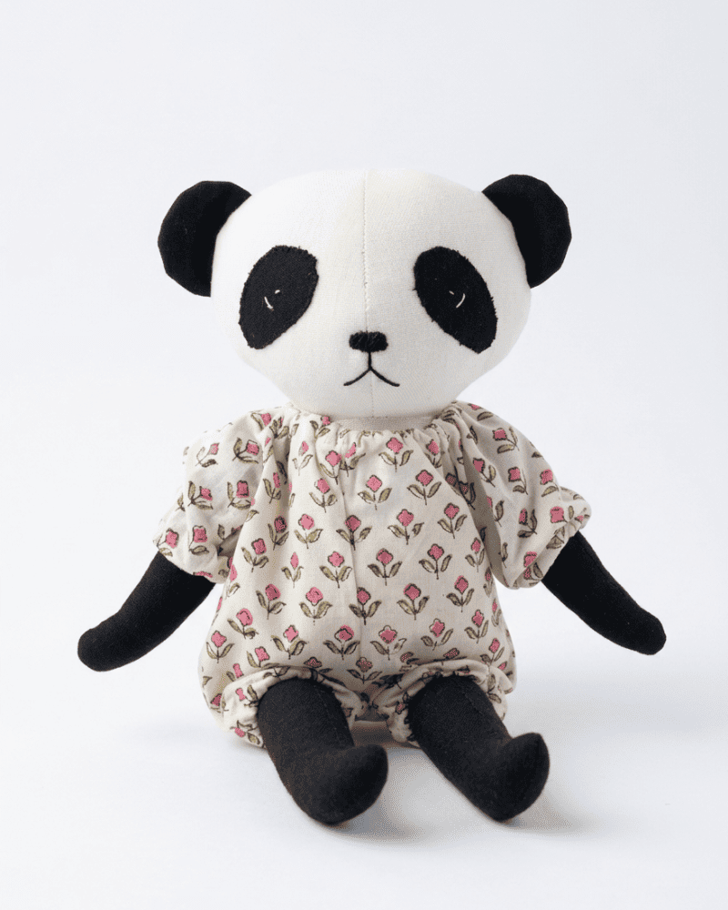 Panda plush toy with a floral dress on a white background